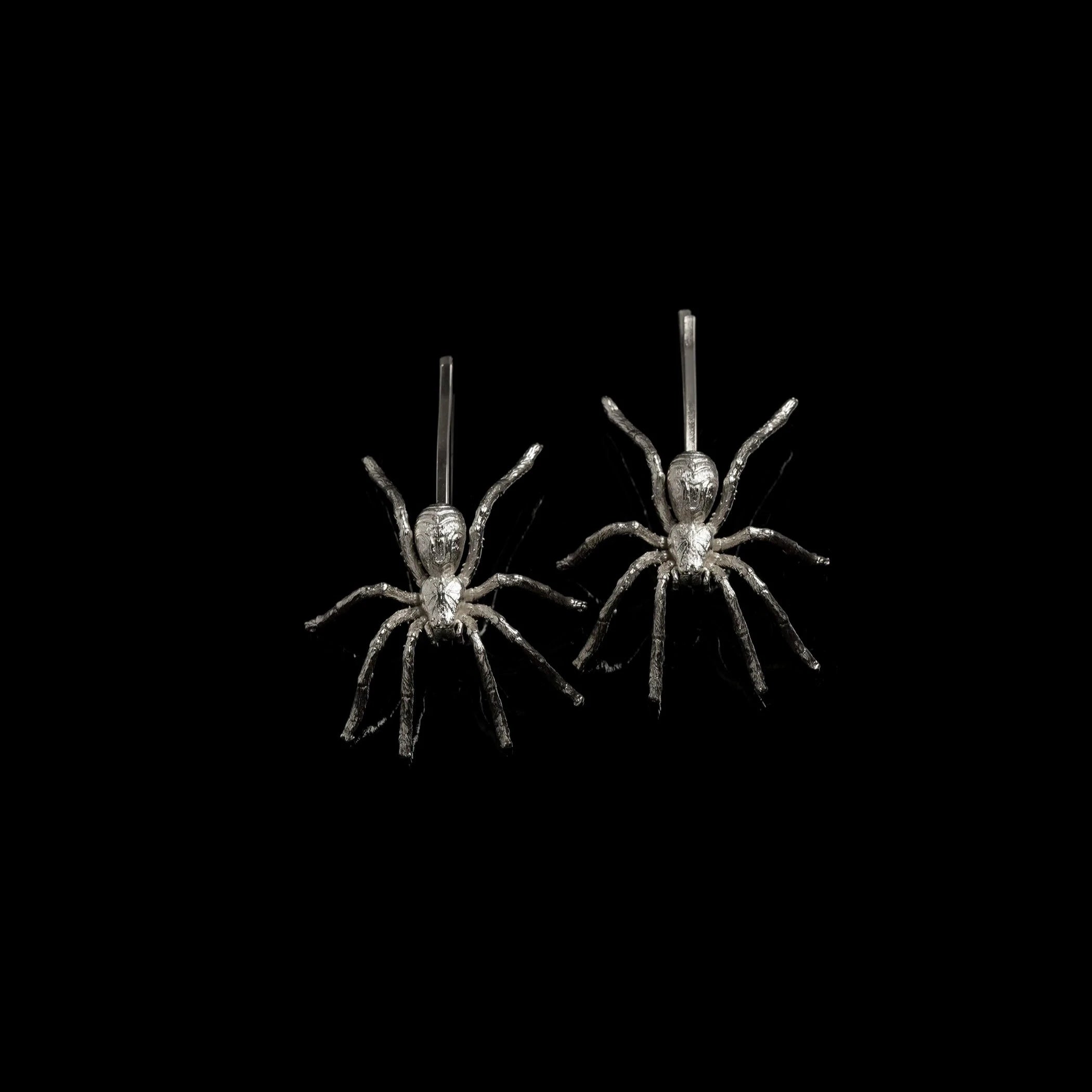 Rhodium spider slides against black background.